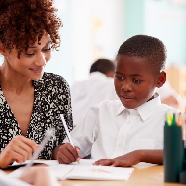Teacher with male student in class