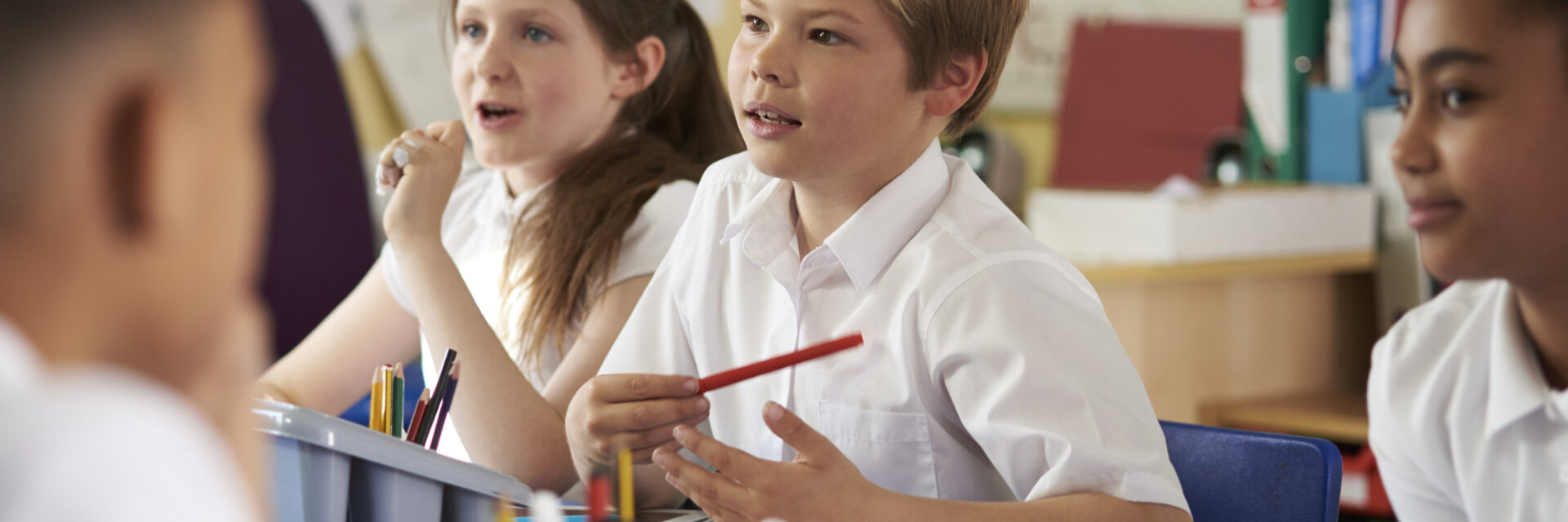 Pupils in class listening to the teacher