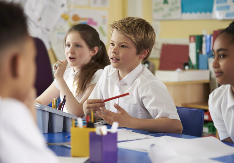 Pupils in class listening to the teacher